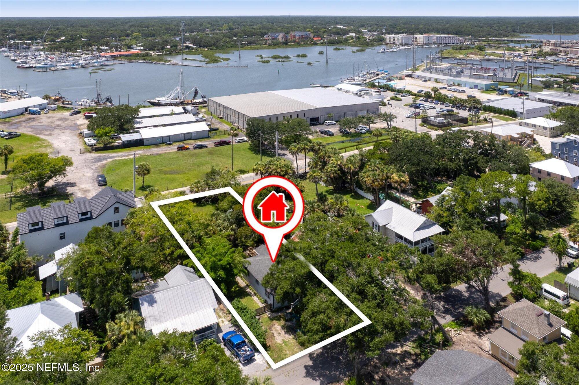 60 Weeden Street St. Augustine, FL 32084 - Photo 34 of 46 an aerial view of a house with a yard and lake view
