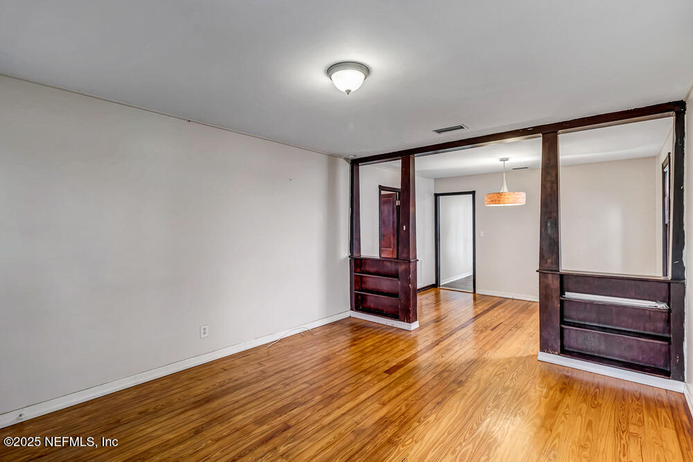 60 Weeden Street St. Augustine, FL 32084 - Photo 4 of 46 an empty room with wooden floor and furniture