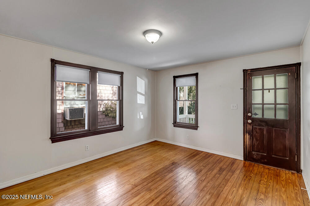 60 Weeden Street St. Augustine, FL 32084 - Photo 5 of 46 a view of an empty room with wooden floor and a window