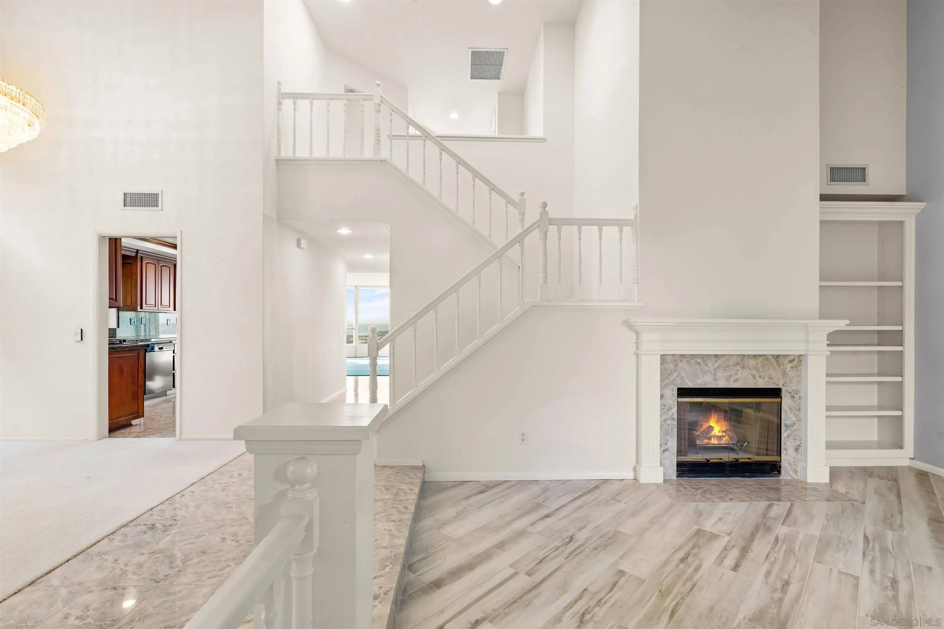 13286 Ocean Vista Road San Diego, CA 92130 - Photo 21 of 66 a view of a livingroom with wooden floor and a fireplace