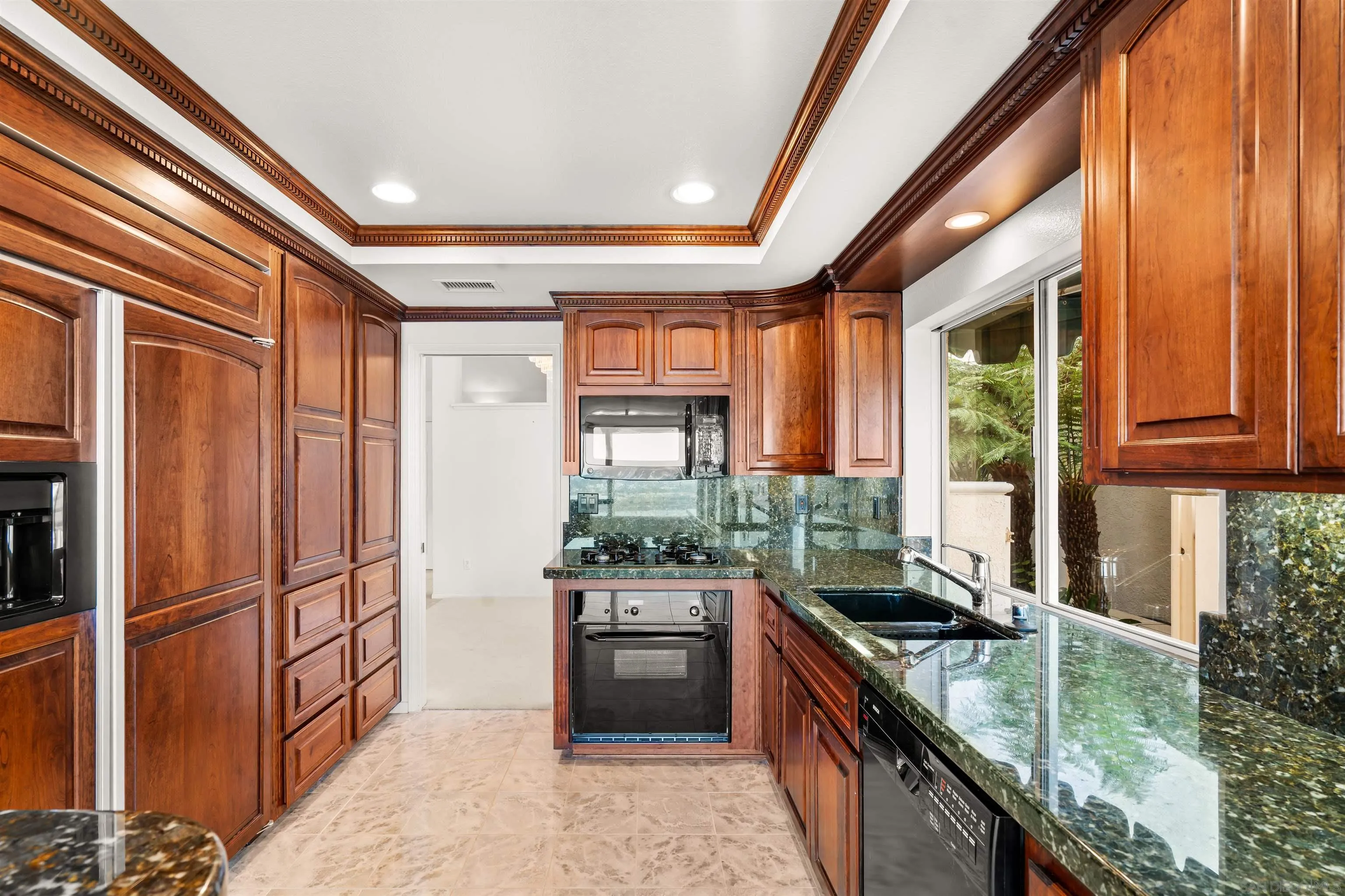 13286 Ocean Vista Road San Diego, CA 92130 - Photo 35 of 66 a kitchen with granite countertop a sink a counter top space and stainless steel appliances