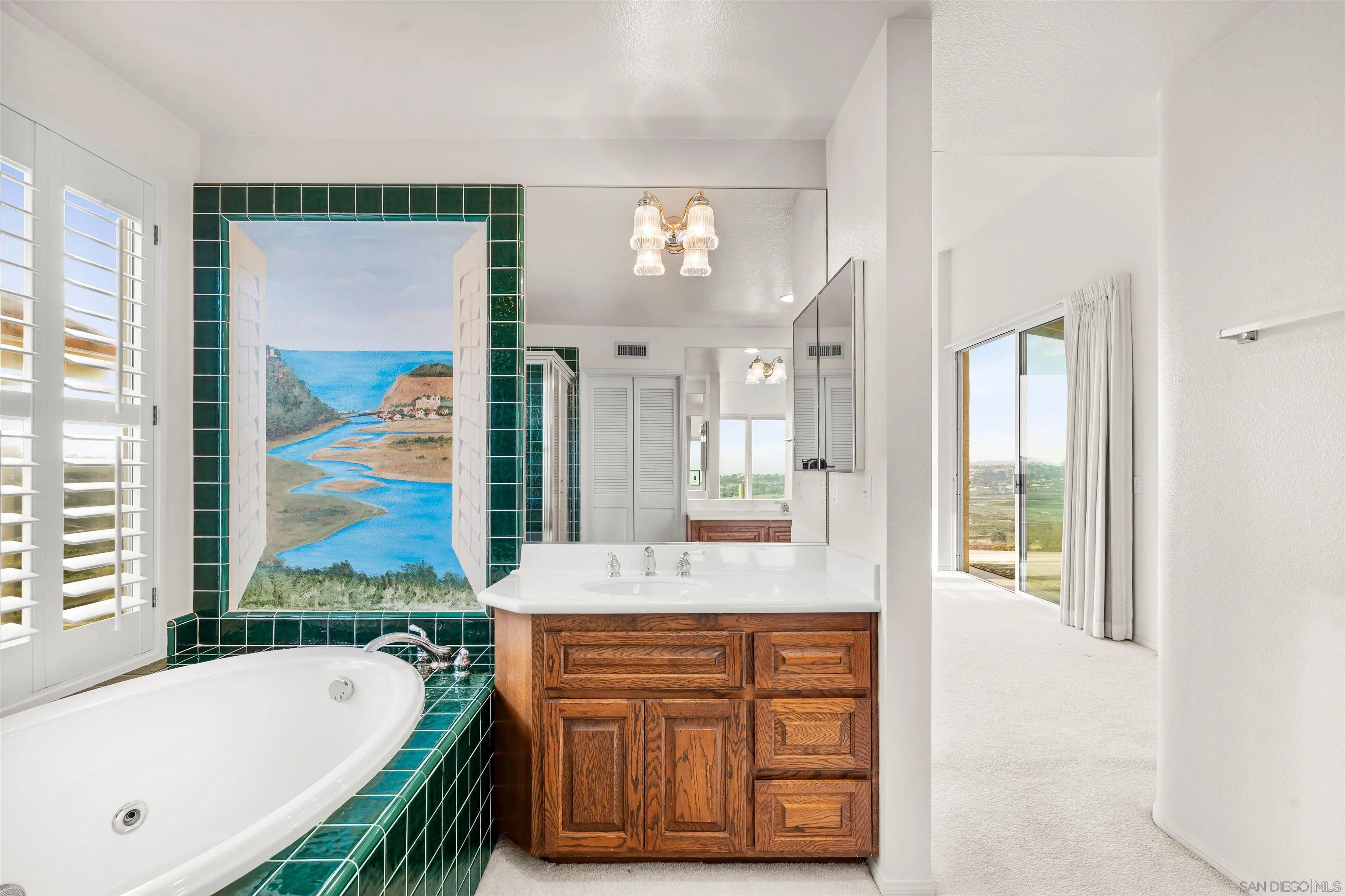 13286 Ocean Vista Road San Diego, CA 92130 - Photo 44 of 66 a bathroom with a granite countertop tub a sink and a large mirror