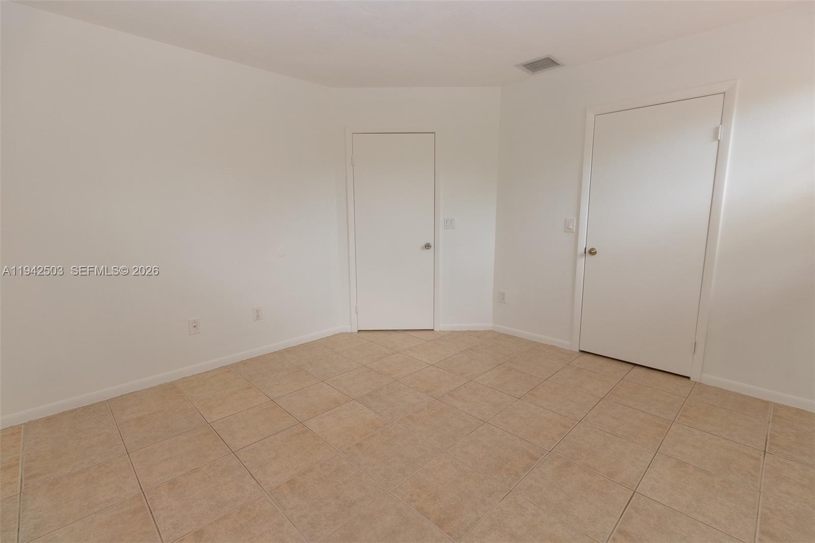 18328 Northwest 68th Avenue, Unit P Hialeah, FL 33015 - Photo 13 of 26 a view of an empty room and chandelier fan