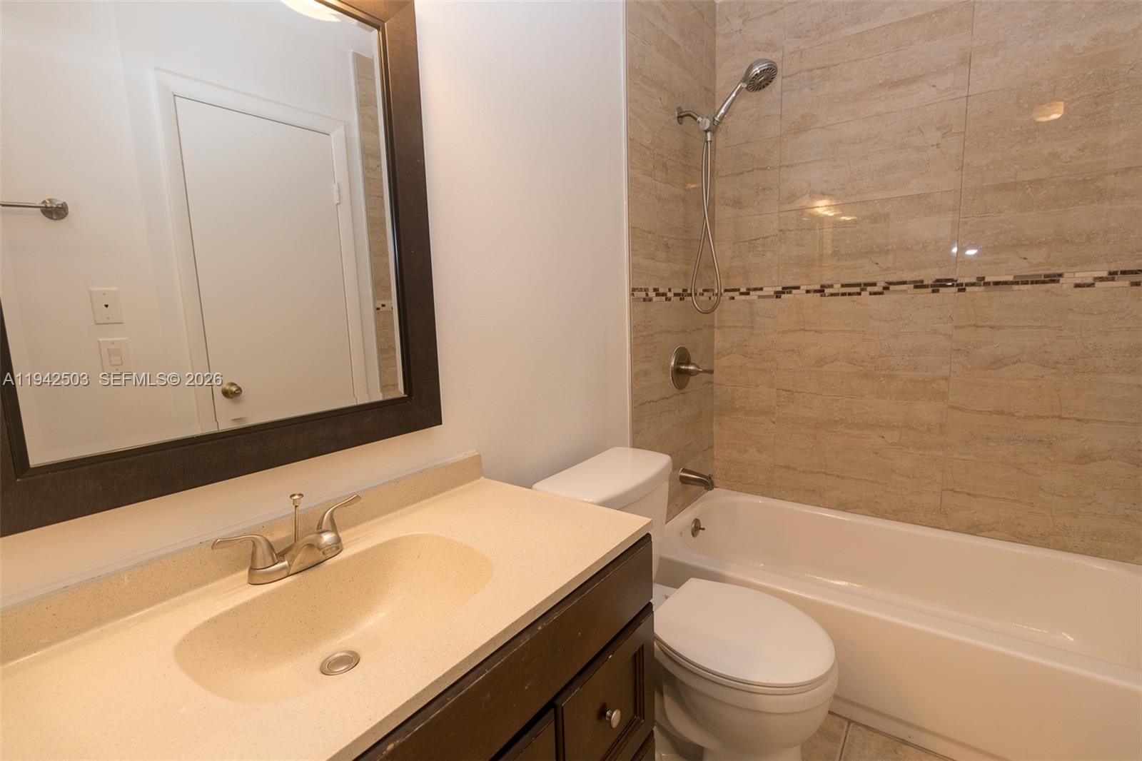 18328 Northwest 68th Avenue, Unit P Hialeah, FL 33015 - Photo 16 of 26 a bathroom with a sink toilet vanity and shower