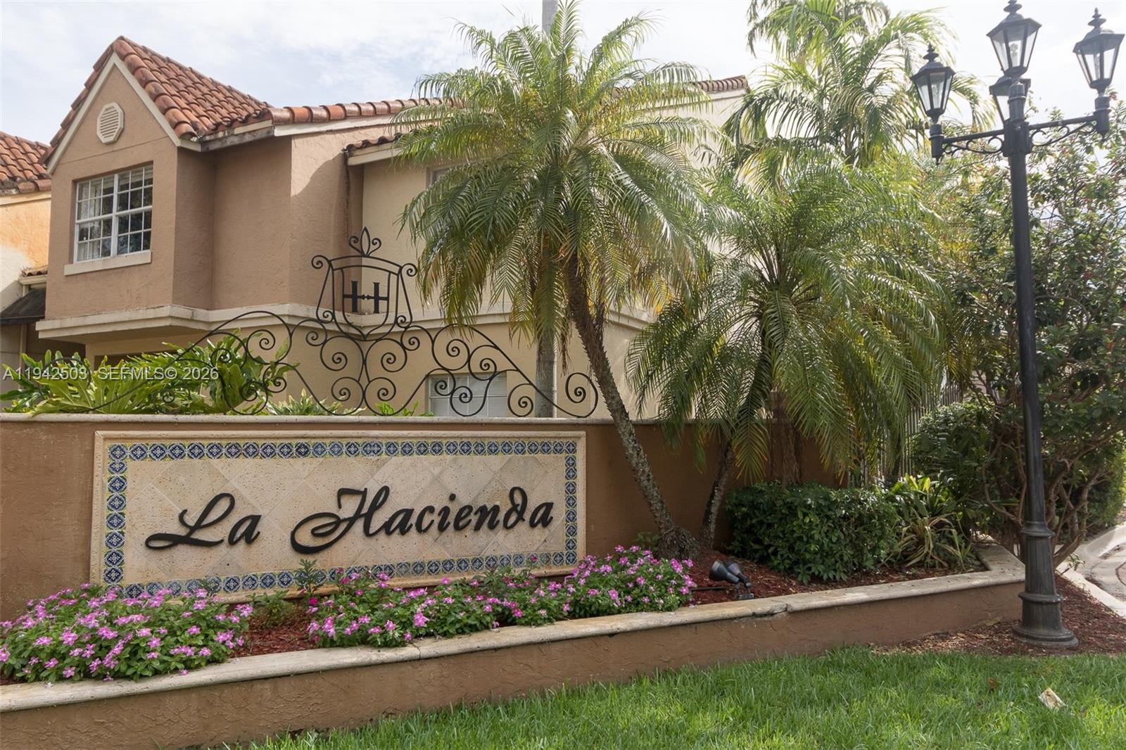 18328 Northwest 68th Avenue, Unit P Hialeah, FL 33015 - Photo 18 of 26 a sign on the side of a building