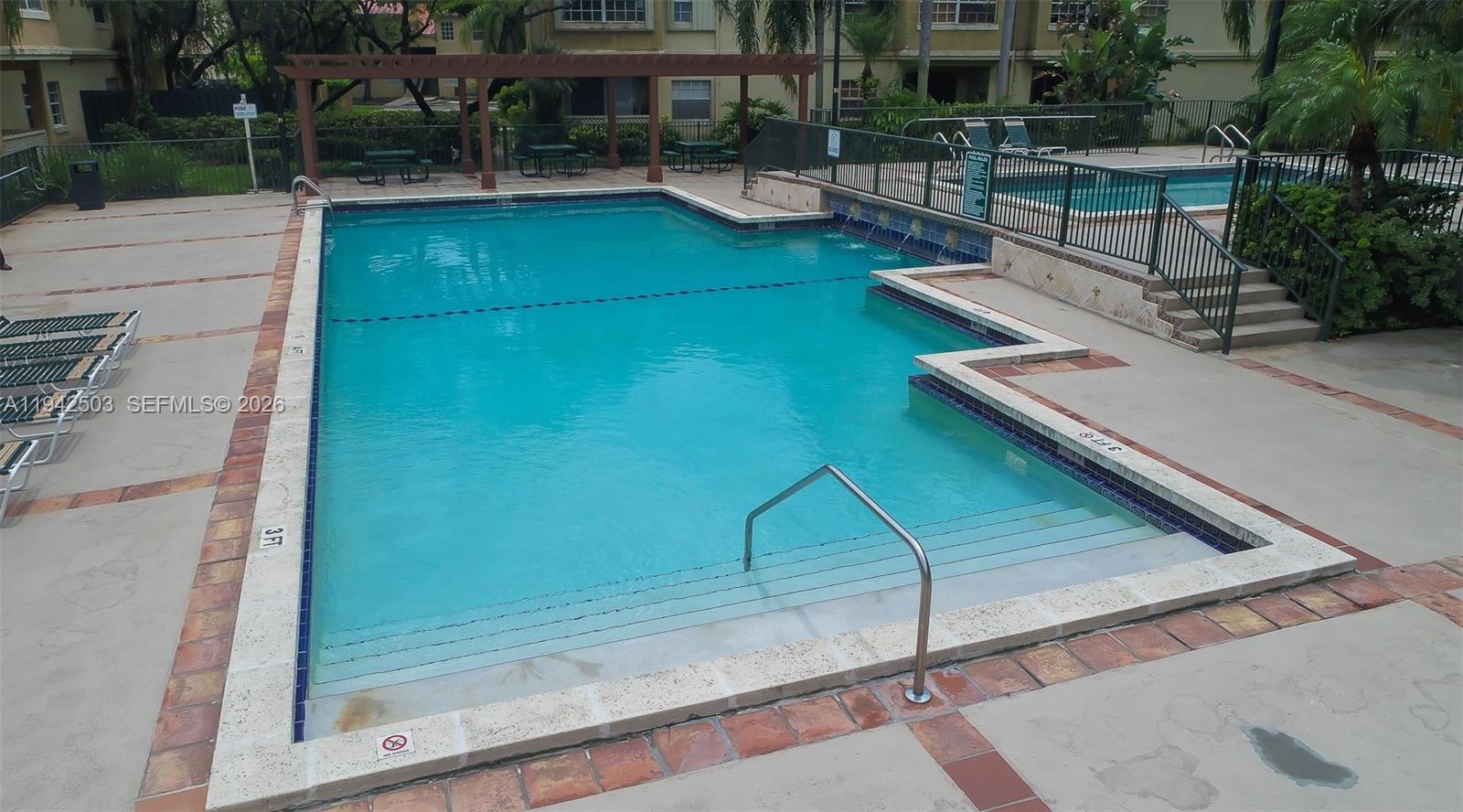 18328 Northwest 68th Avenue, Unit P Hialeah, FL 33015 - Photo 23 of 26 a view of swimming pool with outdoor seating and plants