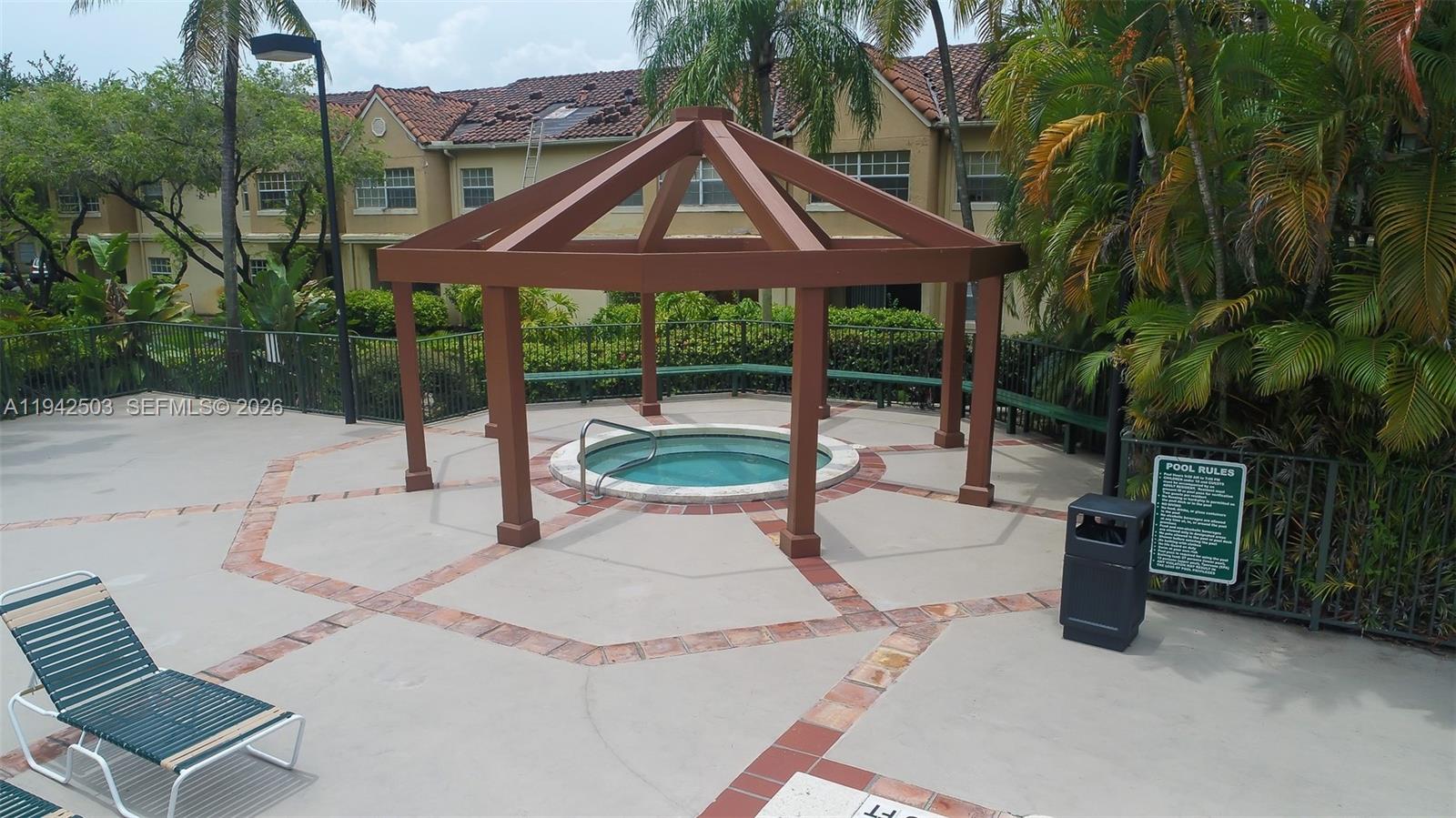 18328 Northwest 68th Avenue, Unit P Hialeah, FL 33015 - Photo 24 of 26 a front view of a house with garden