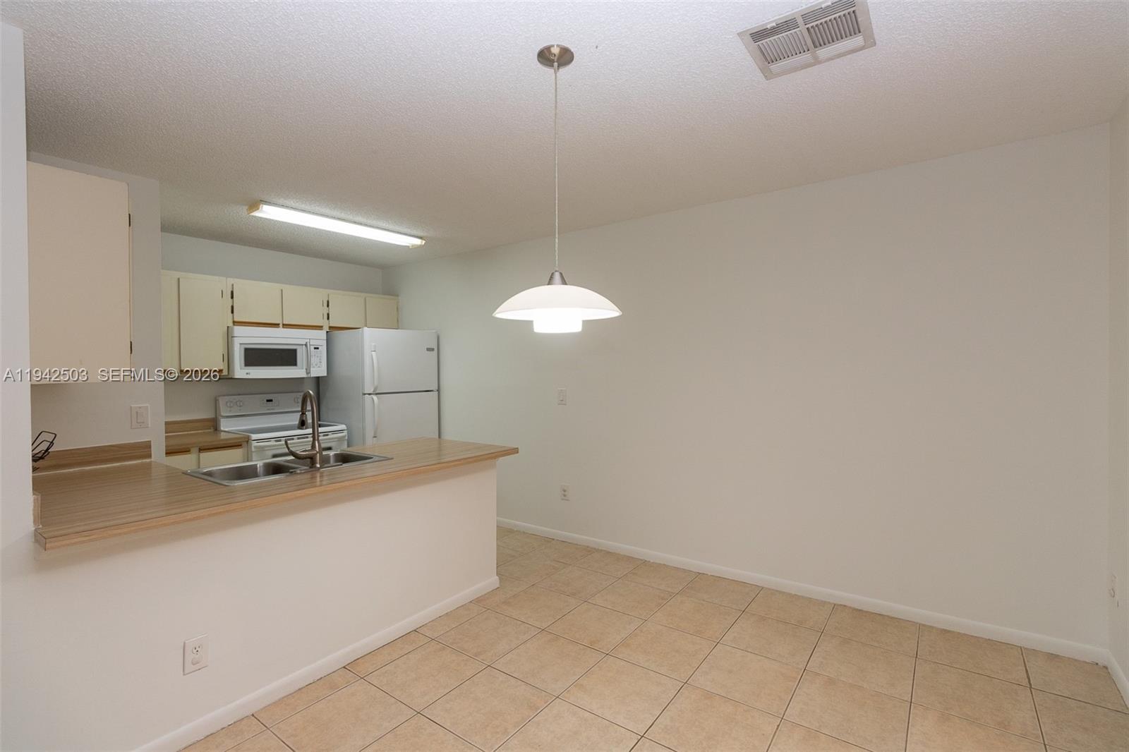 18328 Northwest 68th Avenue, Unit P Hialeah, FL 33015 - Photo 6 of 26 a kitchen with a sink cabinets and appliances