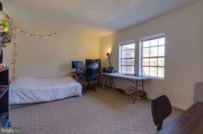 1924 North Rhodes Street, Unit 88 Arlington, VA 22201 - Photo 12 of 20 a bedroom with a bed chair and a window
