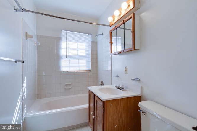 1924 North Rhodes Street, Unit 88 Arlington, VA 22201 - Photo 13 of 20 a bathroom with a sink a toilet and shower