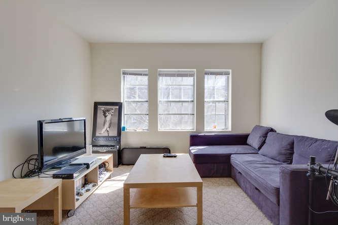 1924 North Rhodes Street, Unit 88 Arlington, VA 22201 - Photo 6 of 20 a living room with furniture and a flat screen tv