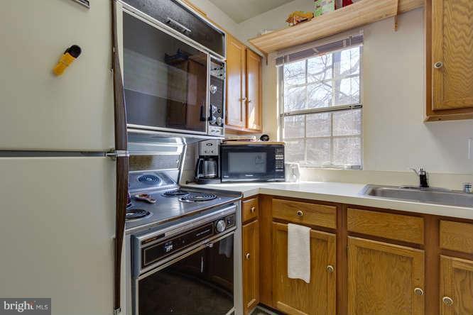 1924 North Rhodes Street, Unit 88 Arlington, VA 22201 - Photo 9 of 20 a kitchen with a sink cabinets and window