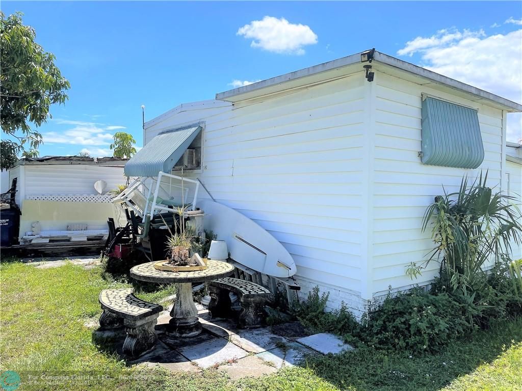1830 Southwest 83rd Terrace Davie, FL 33324 - Photo 13 of 15 a view of a backyard with plants and a fountain
