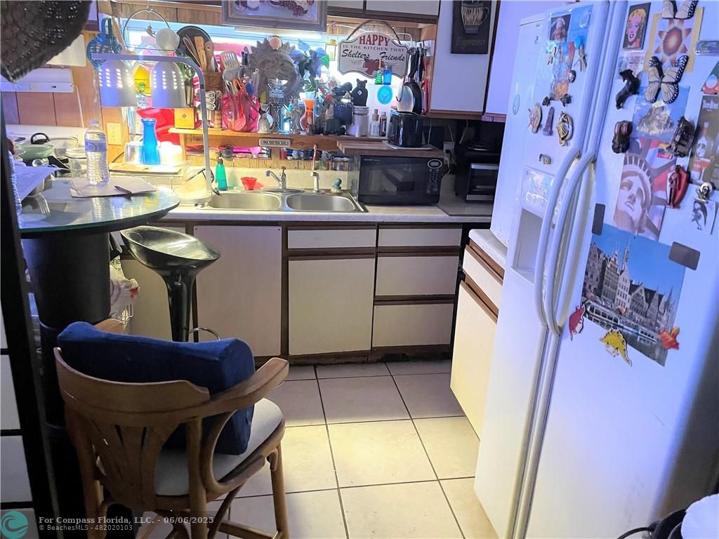 1830 Southwest 83rd Terrace Davie, FL 33324 - Photo 4 of 15 a room with stainless steel appliances kitchen island granite countertop furniture and a rug