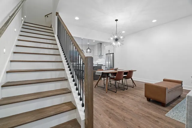 a view of a livingroom with furniture and stairs