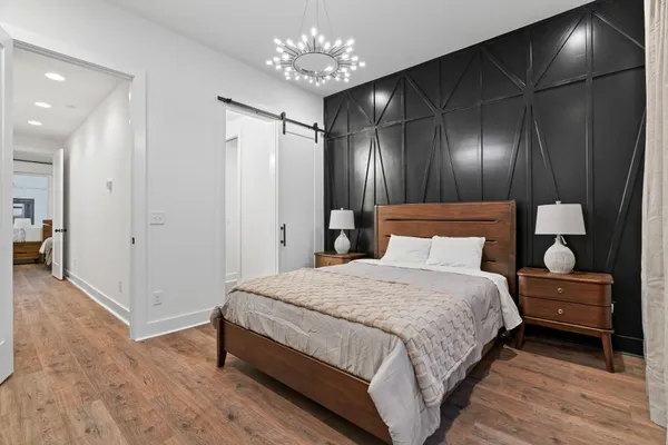 a bedroom with a bed and a chandelier