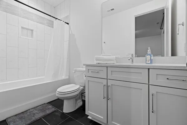 a bathroom with a shower and a toilet