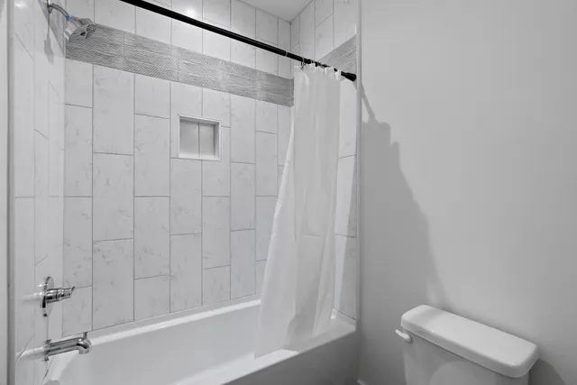 a bathroom with a sink toilet and mirror