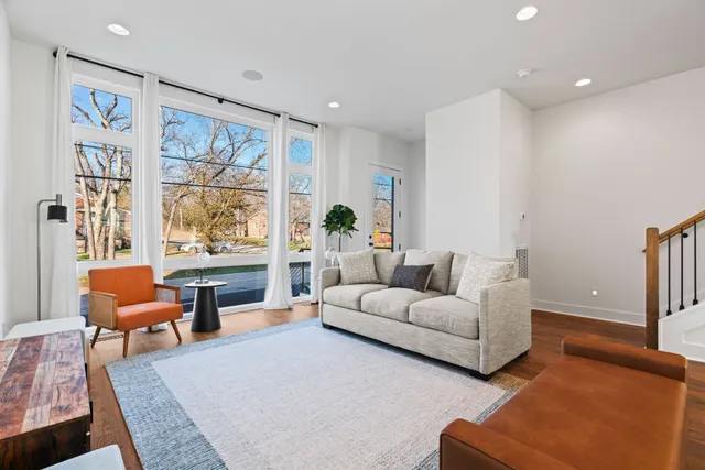 a living room with furniture and a painting on the wall