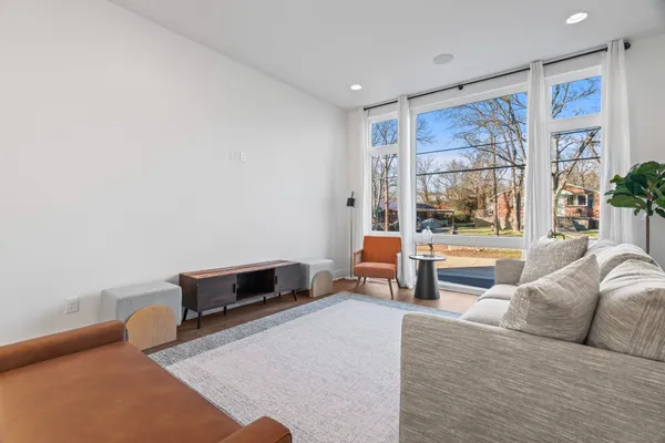 a living room with furniture and a painting on the wall