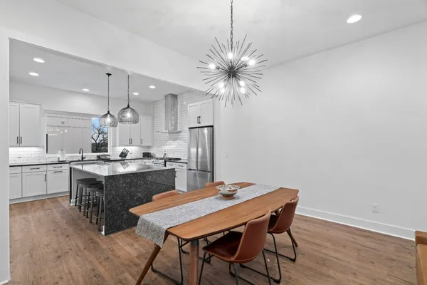 a kitchen with a table and chairs in it