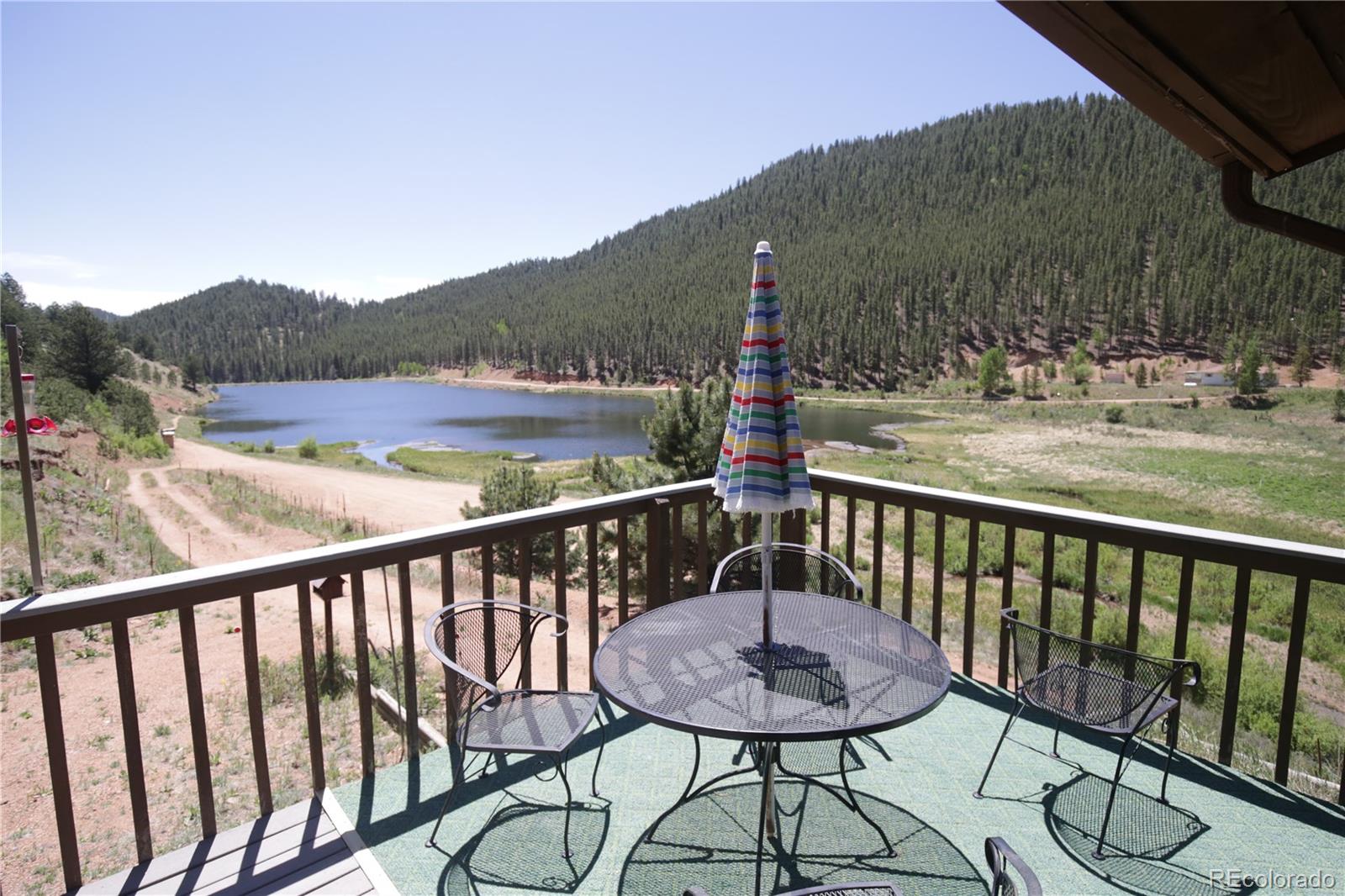 a view of a balcony with mountain view and wooden floor