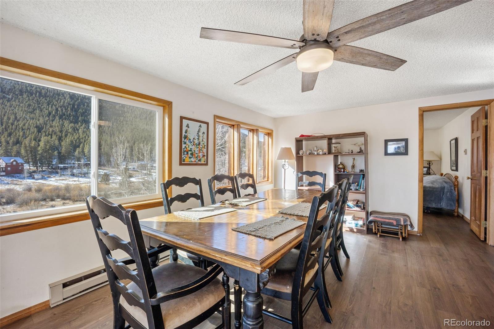 415 Bishop Road Bailey, CO 80421 - Photo 11 of 39 a view of a dining room with furniture window and wooden floor