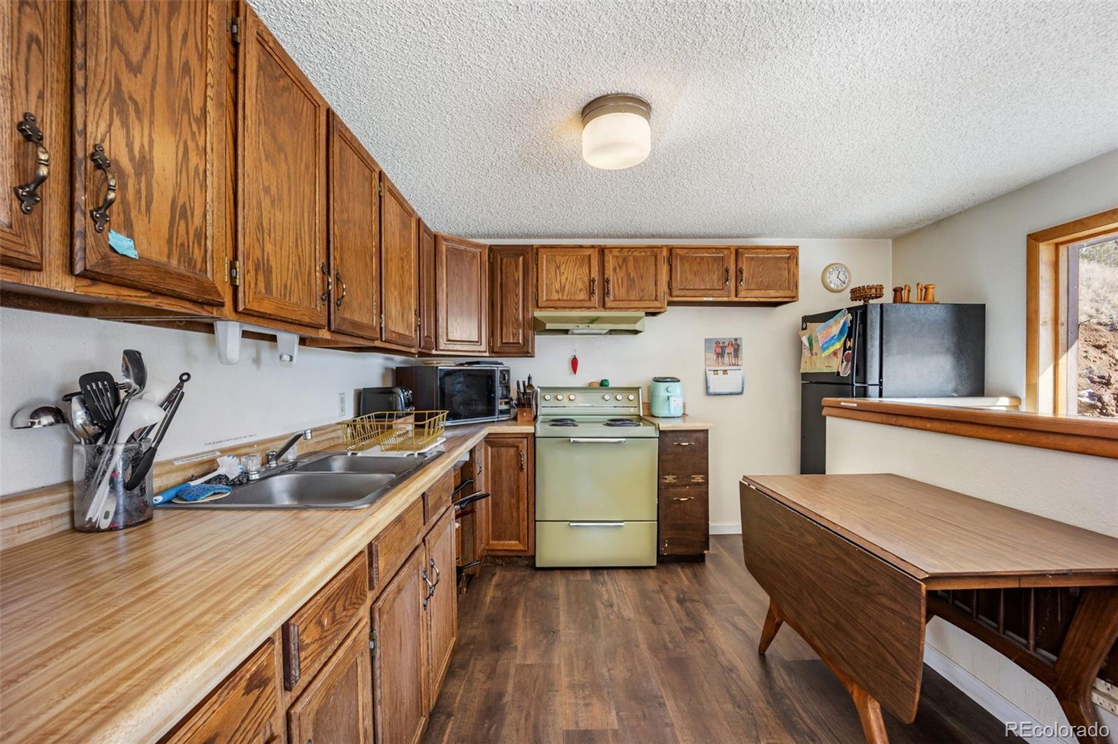 415 Bishop Road Bailey, CO 80421 - Photo 14 of 39 a kitchen with a sink cabinets and window