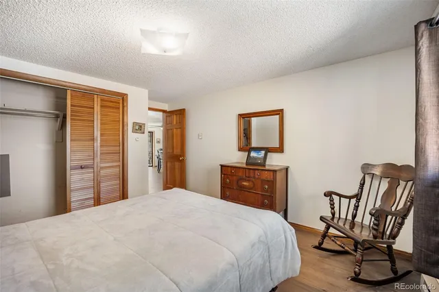 a bedroom with a large bed and a dresser