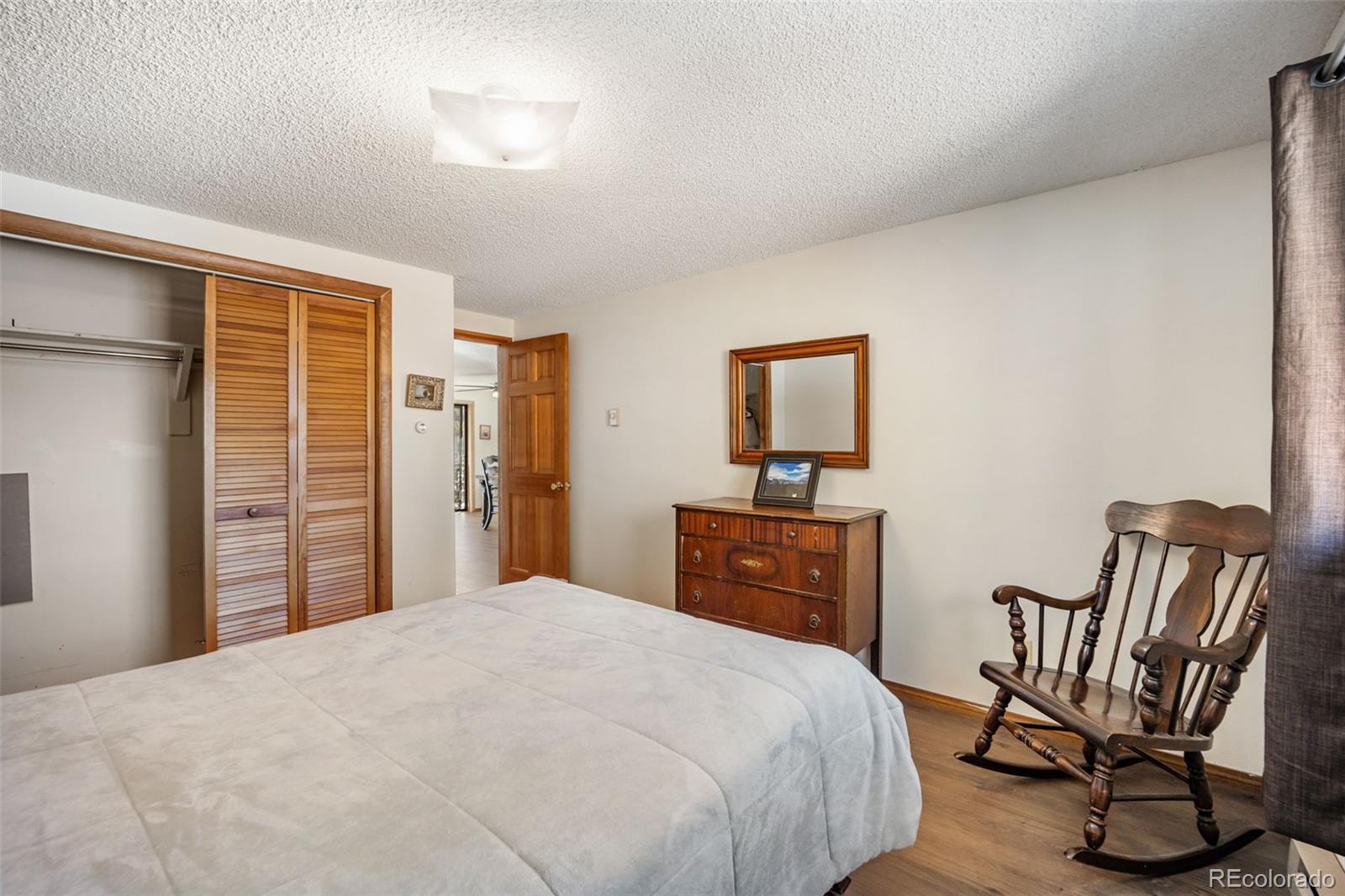 415 Bishop Road Bailey, CO 80421 - Photo 20 of 39 a bedroom with a bed and furniture