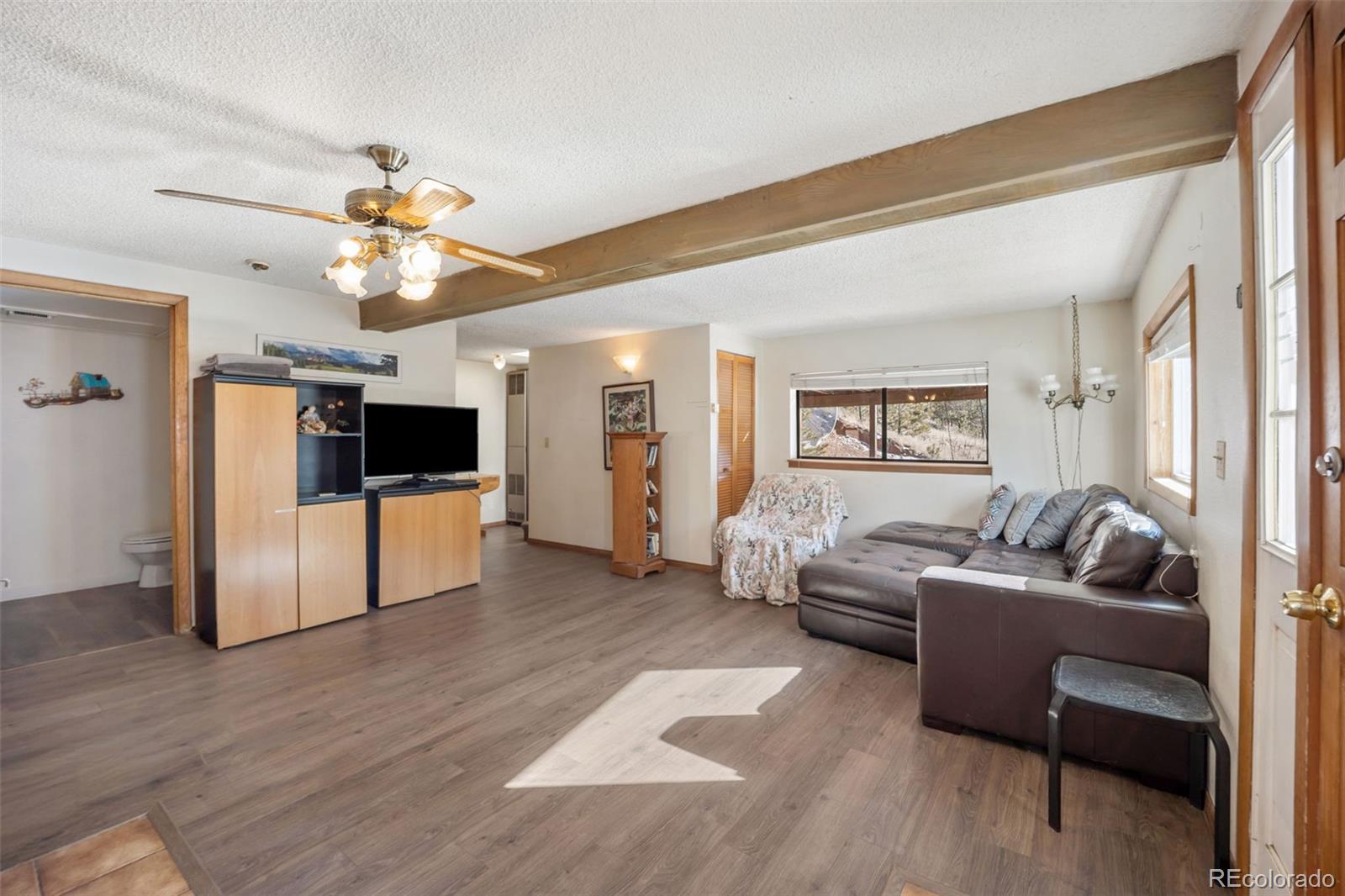 415 Bishop Road Bailey, CO 80421 - Photo 4 of 39 a living room with furniture and a flat screen tv