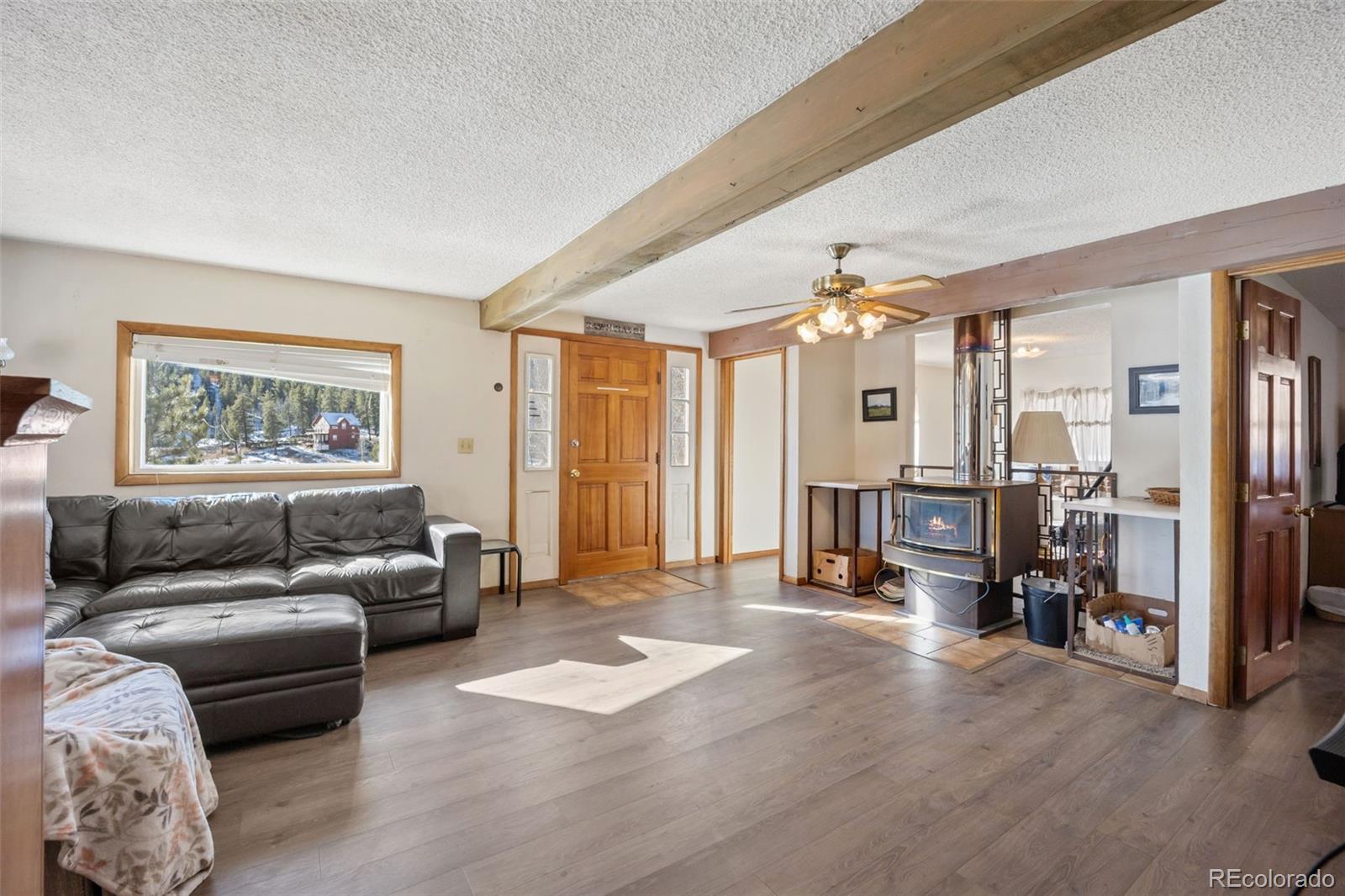 415 Bishop Road Bailey, CO 80421 - Photo 5 of 39 a living room with furniture and a window