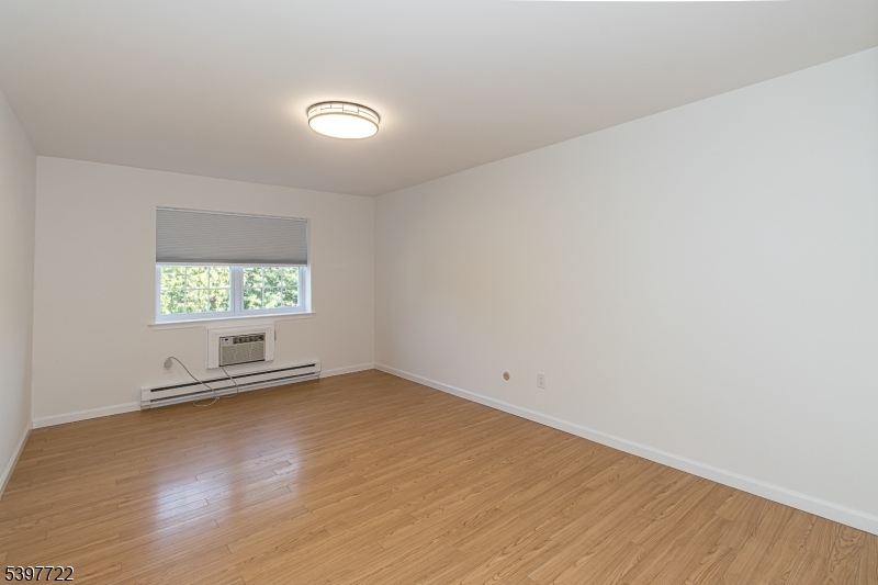 530 Park Avenue, Unit 214 Scotch Plains, NJ 07076 - Photo 14 of 17 an empty room with wooden floor and windows