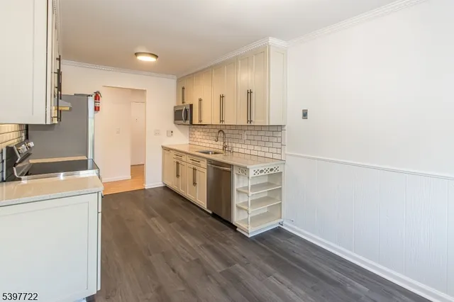 a kitchen with a sink a stove and cabinets