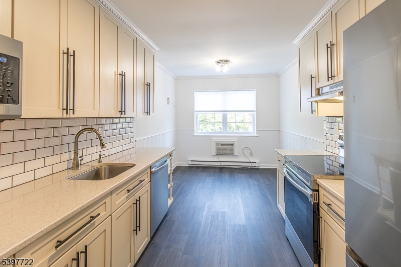 530 Park Avenue, Unit 214 Scotch Plains, NJ 07076 - Photo 6 of 17 a kitchen with a sink a stove and cabinets
