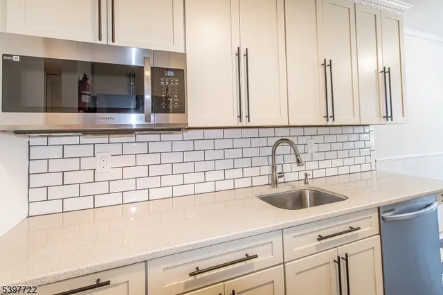 a kitchen with a refrigerator and a stove top oven