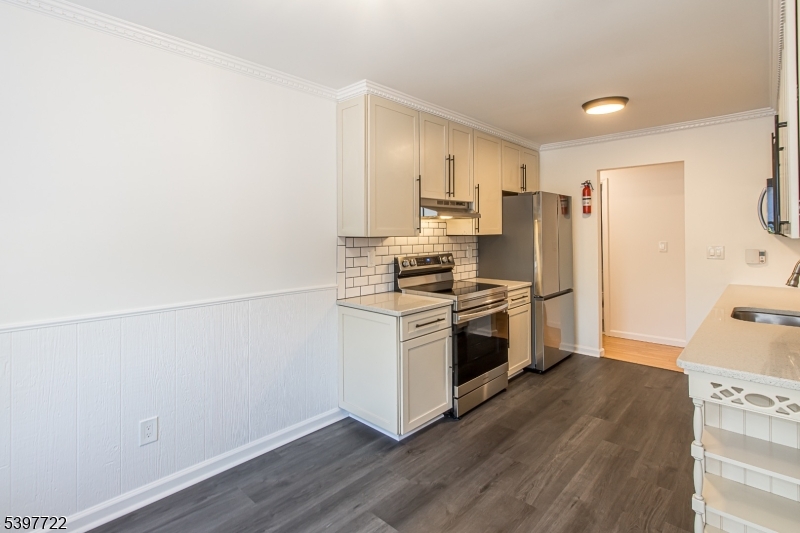530 Park Avenue, Unit 214 Scotch Plains, NJ 07076 - Photo 8 of 17 a kitchen with a refrigerator and a stove top oven