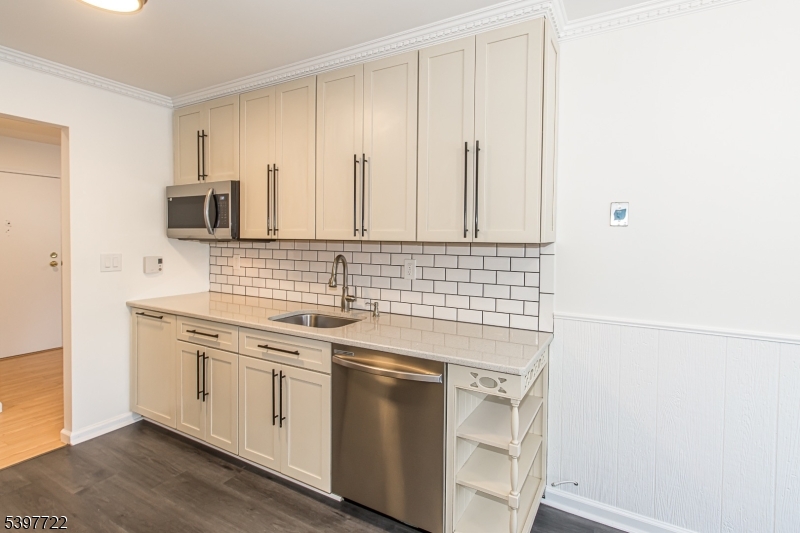 530 Park Avenue, Unit 214 Scotch Plains, NJ 07076 - Photo 9 of 17 a kitchen with granite countertop white cabinets and white appliances