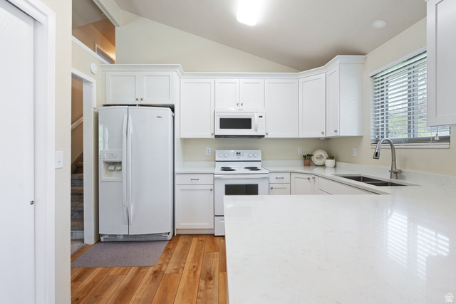 865 South 325 West Orem, UT 84058 - Photo 12 of 38 Kitchen featuring white cabinetry, light-colored countertops, stainless steel sink with pull-down faucet, and wood-finish flooring