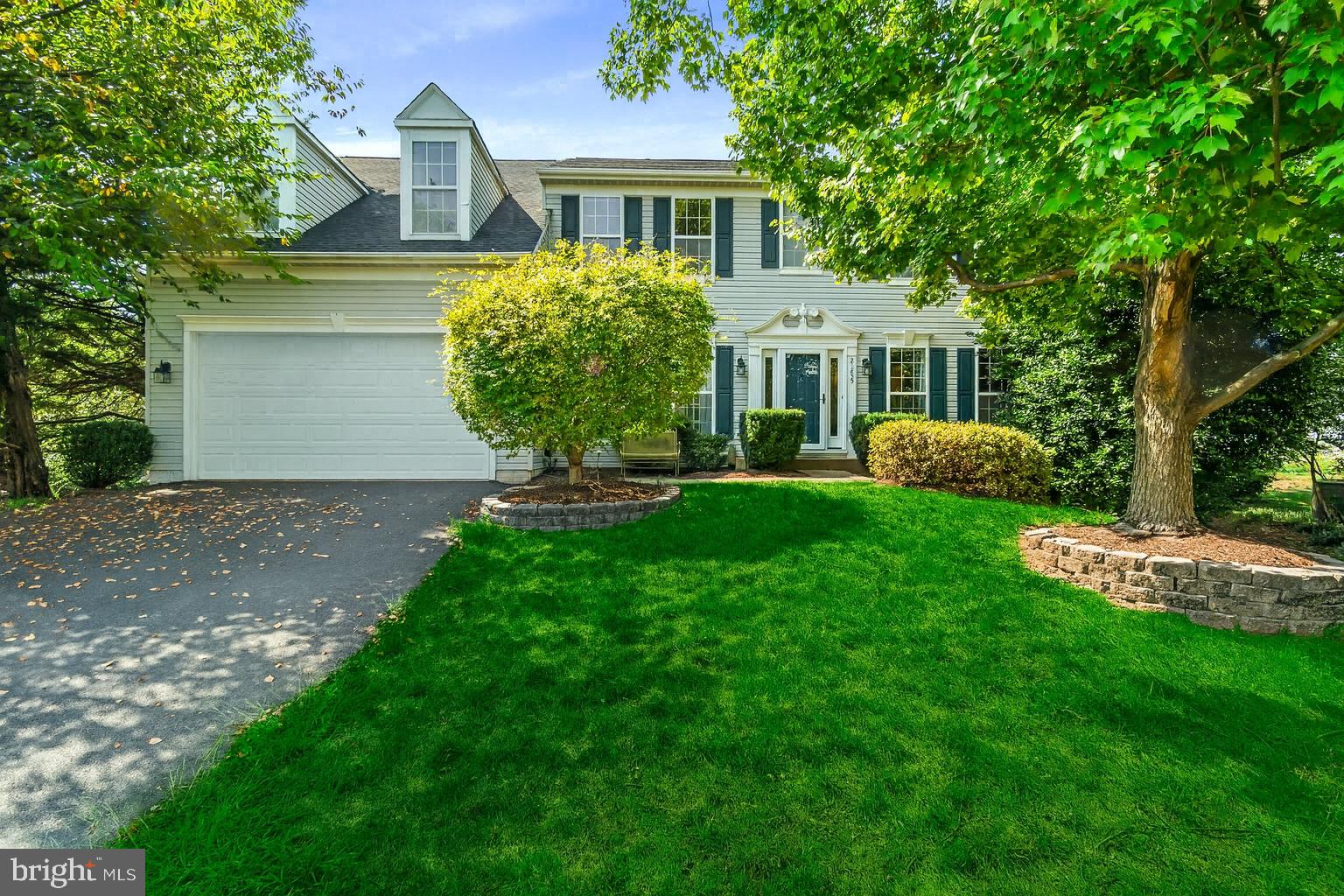 21255 Olive Green Court Ashburn, VA 20147 - Photo 1 of 32 a front view of a house with a yard and trees