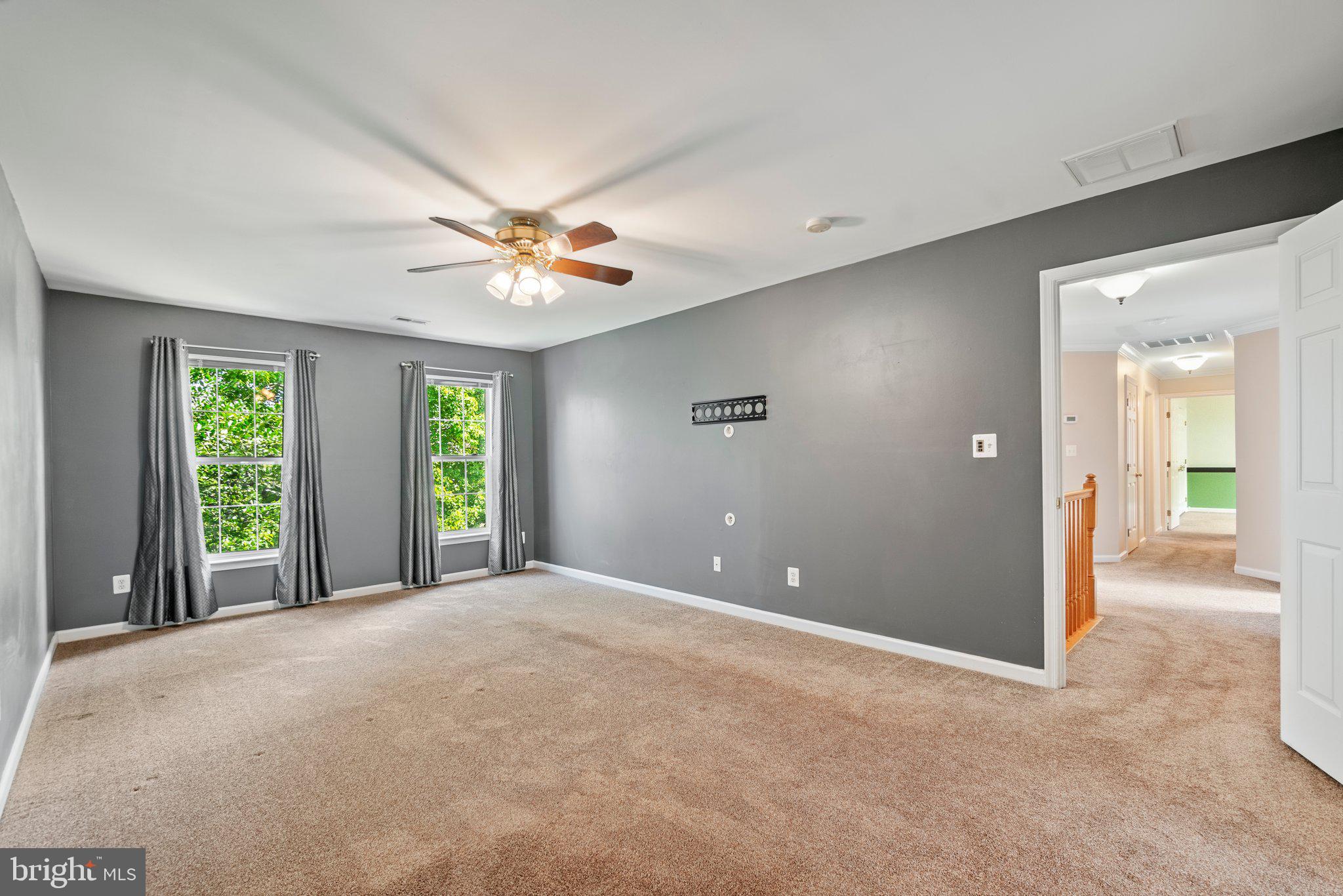 21255 Olive Green Court Ashburn, VA 20147 - Photo 16 of 32 a view of a livingroom with a ceiling fan and window