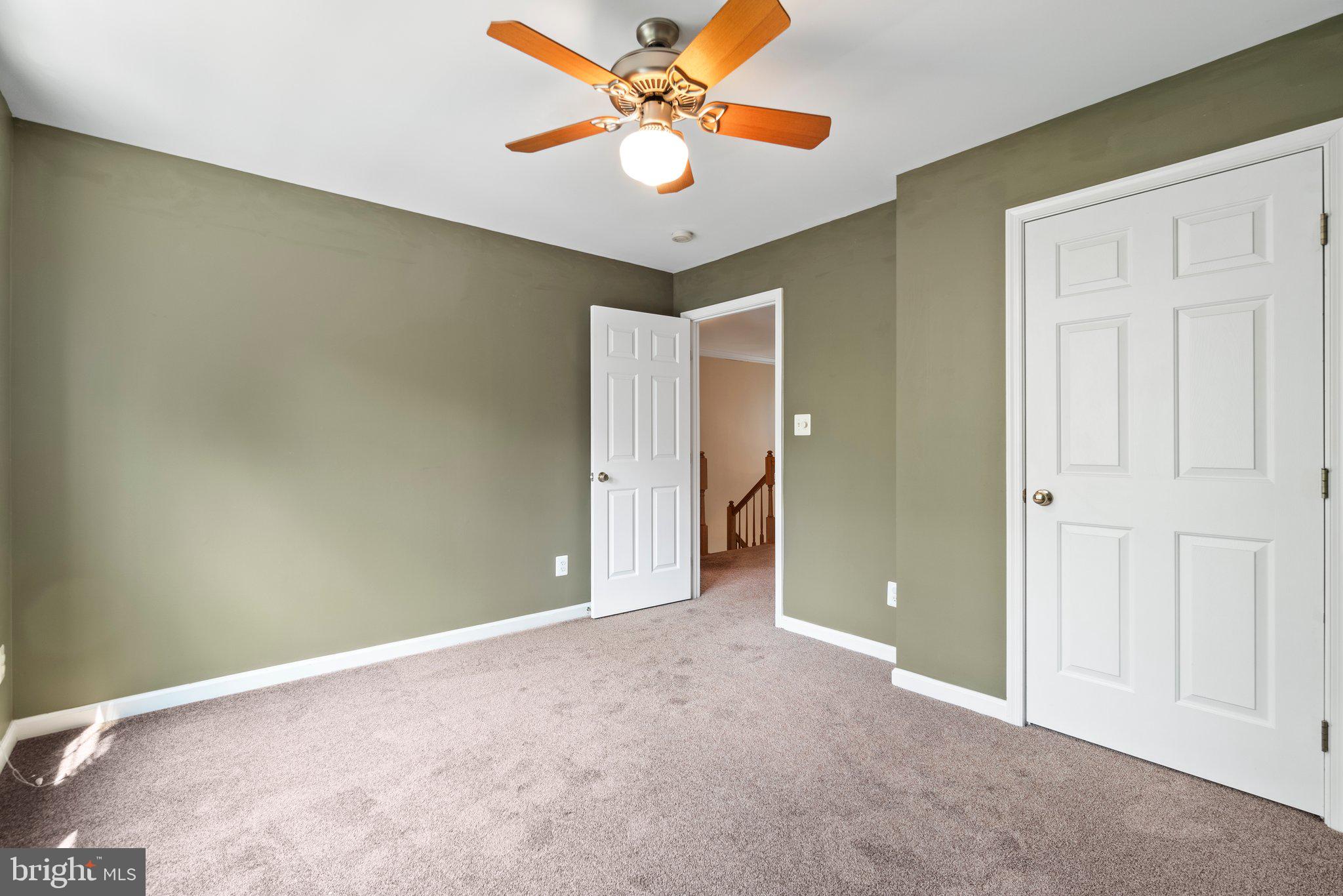 21255 Olive Green Court Ashburn, VA 20147 - Photo 20 of 32 an empty room with closet and a chandelier fan