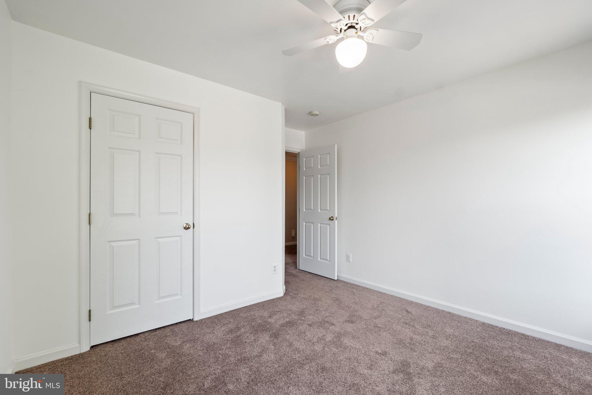 21255 Olive Green Court Ashburn, VA 20147 - Photo 23 of 32 a view of an empty room and chandelier fan