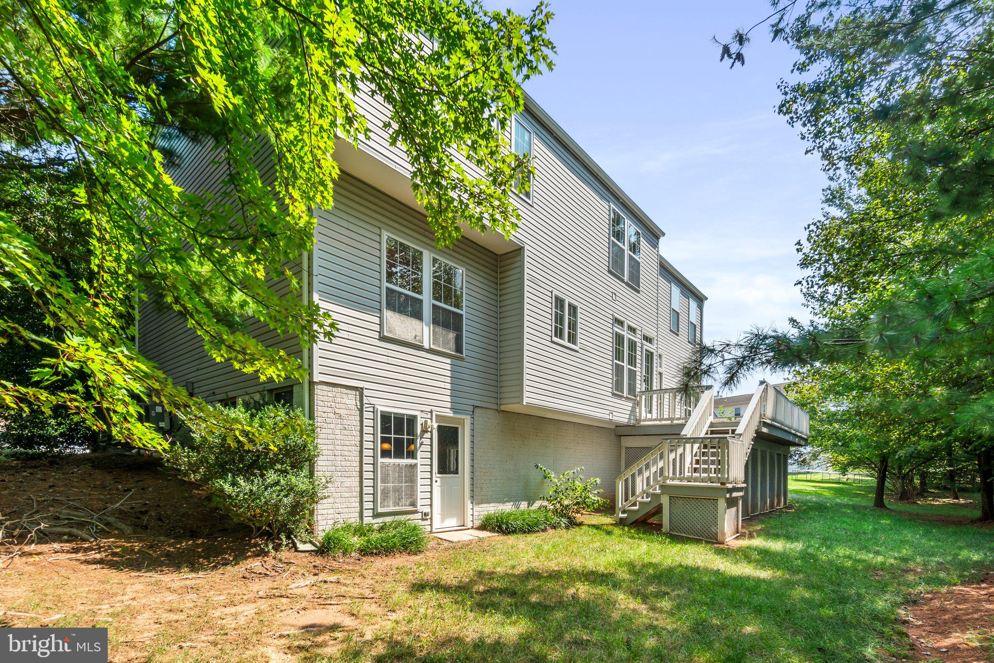 21255 Olive Green Court Ashburn, VA 20147 - Photo 31 of 32 a view of a house with a yard and sitting area