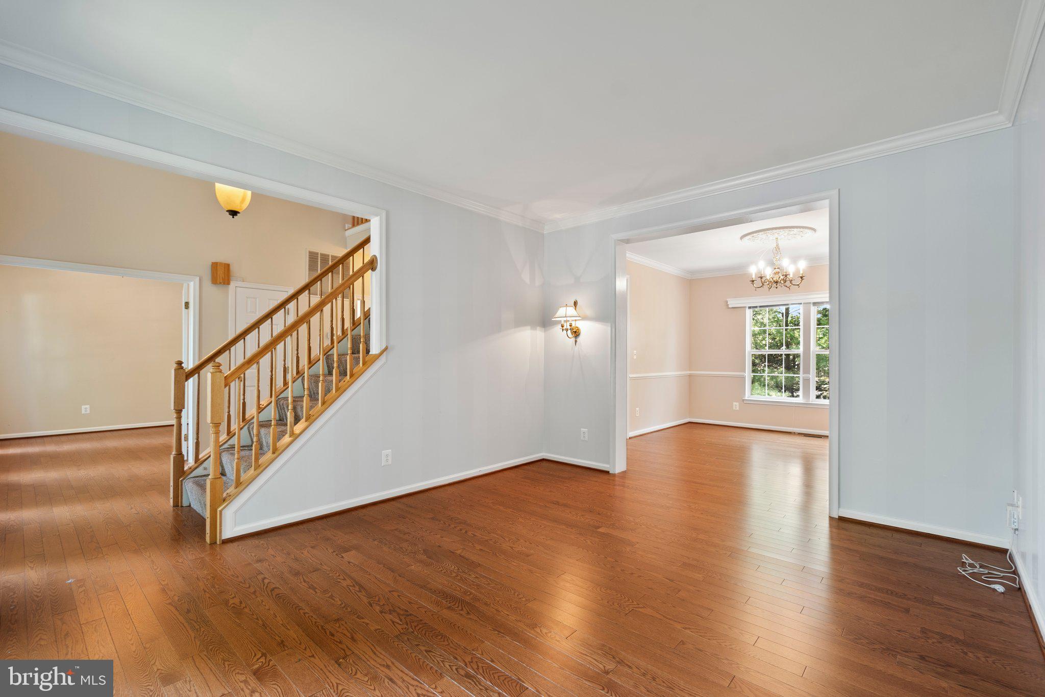 21255 Olive Green Court Ashburn, VA 20147 - Photo 6 of 32 a view of an empty room with wooden floor and a window