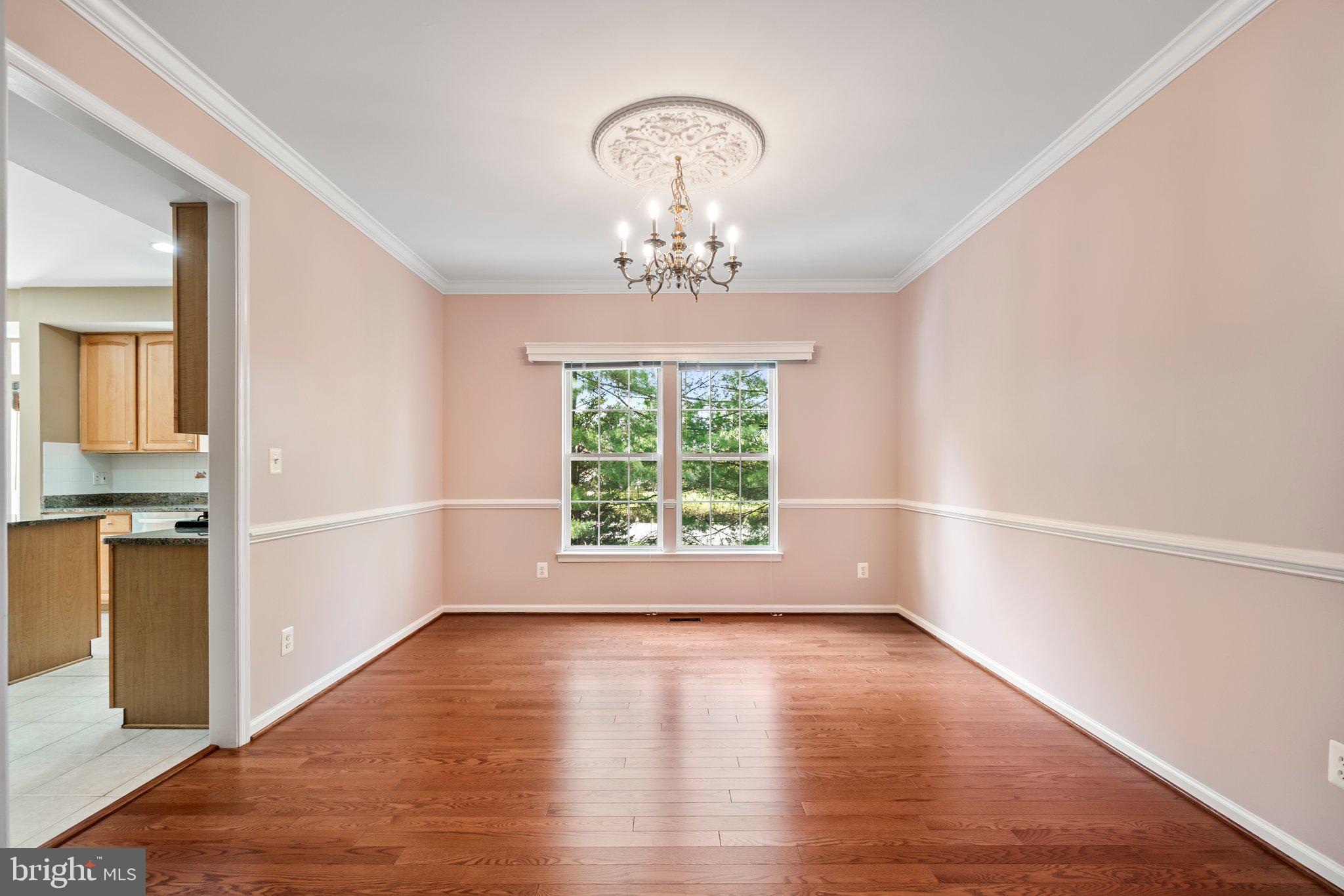 21255 Olive Green Court Ashburn, VA 20147 - Photo 7 of 32 wooden floor in an empty room with a window