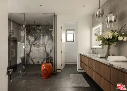 a bathroom with a sink a mirror and shower