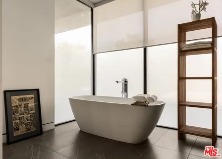 a living room with a window and a glass door