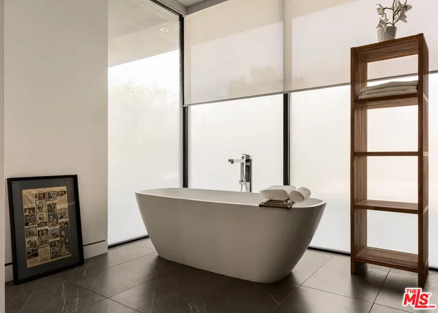 a living room with a window and a glass door