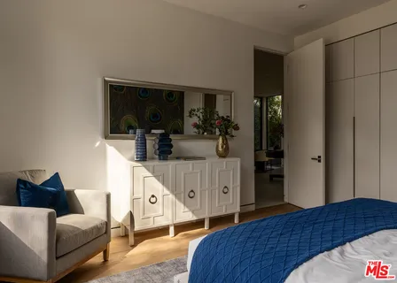 a bedroom with furniture and a window